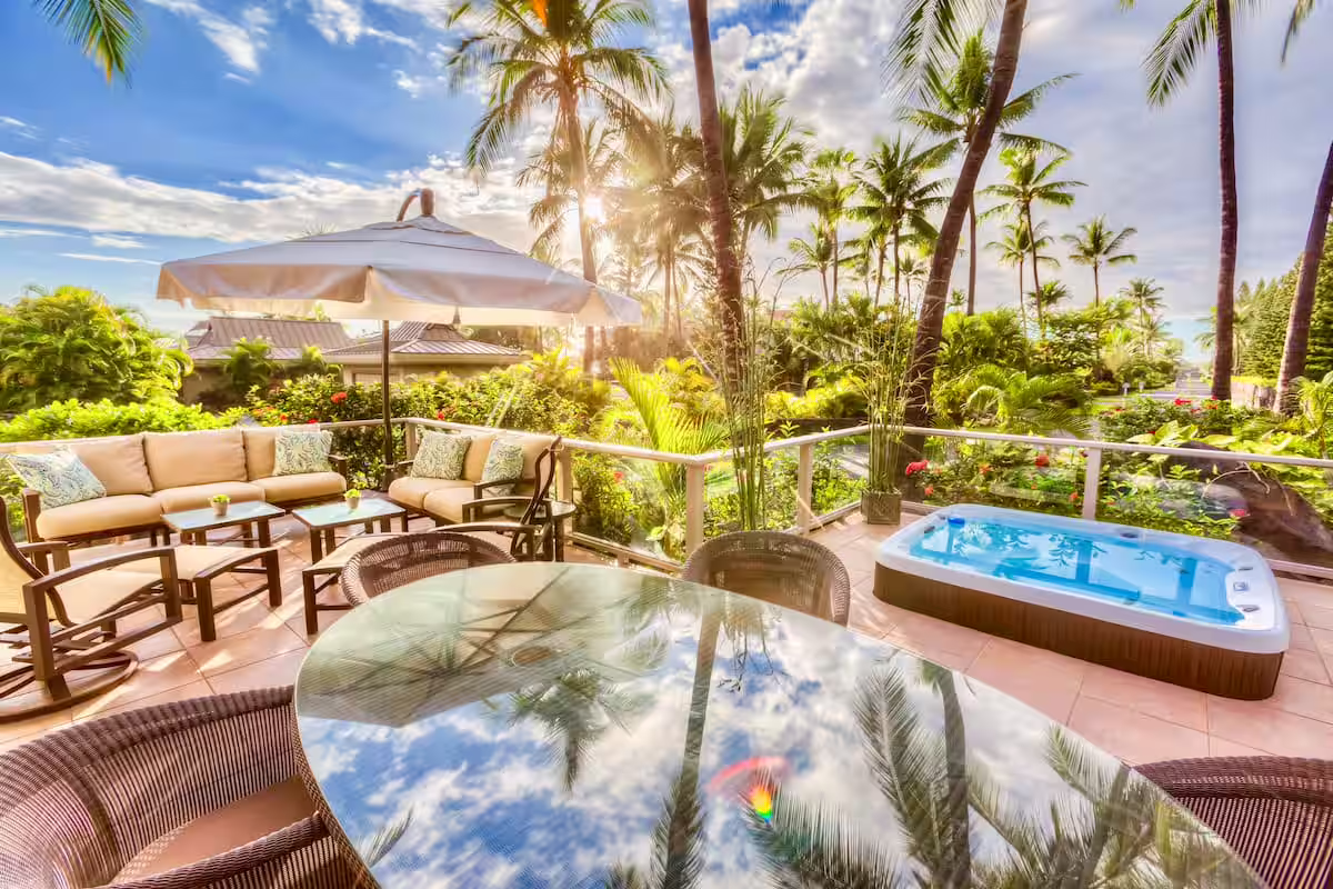 Luxury outdoor lanai with hot tub, comfortable seating, and tropical paradise views - your private retreat at Manta Ray Manor